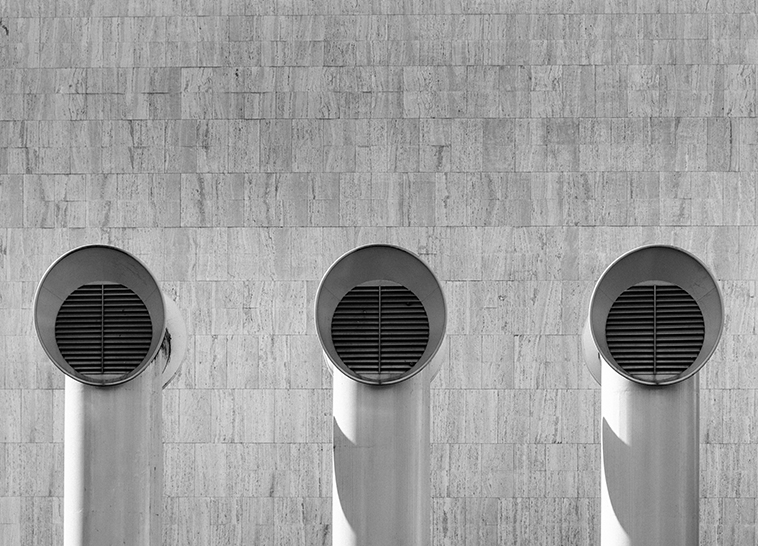 a row of ventilators in front of a building