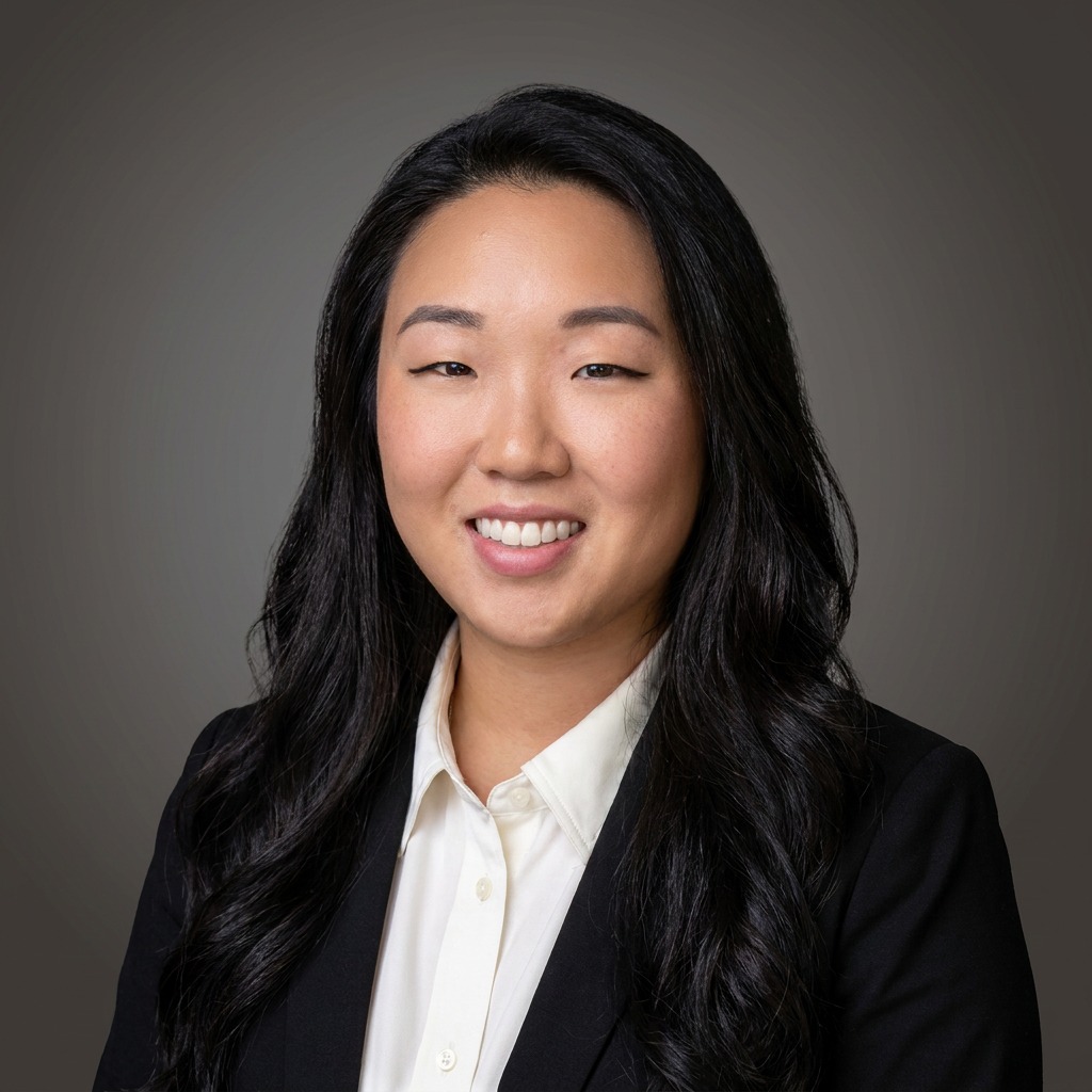 a woman with long black hair wearing a suit