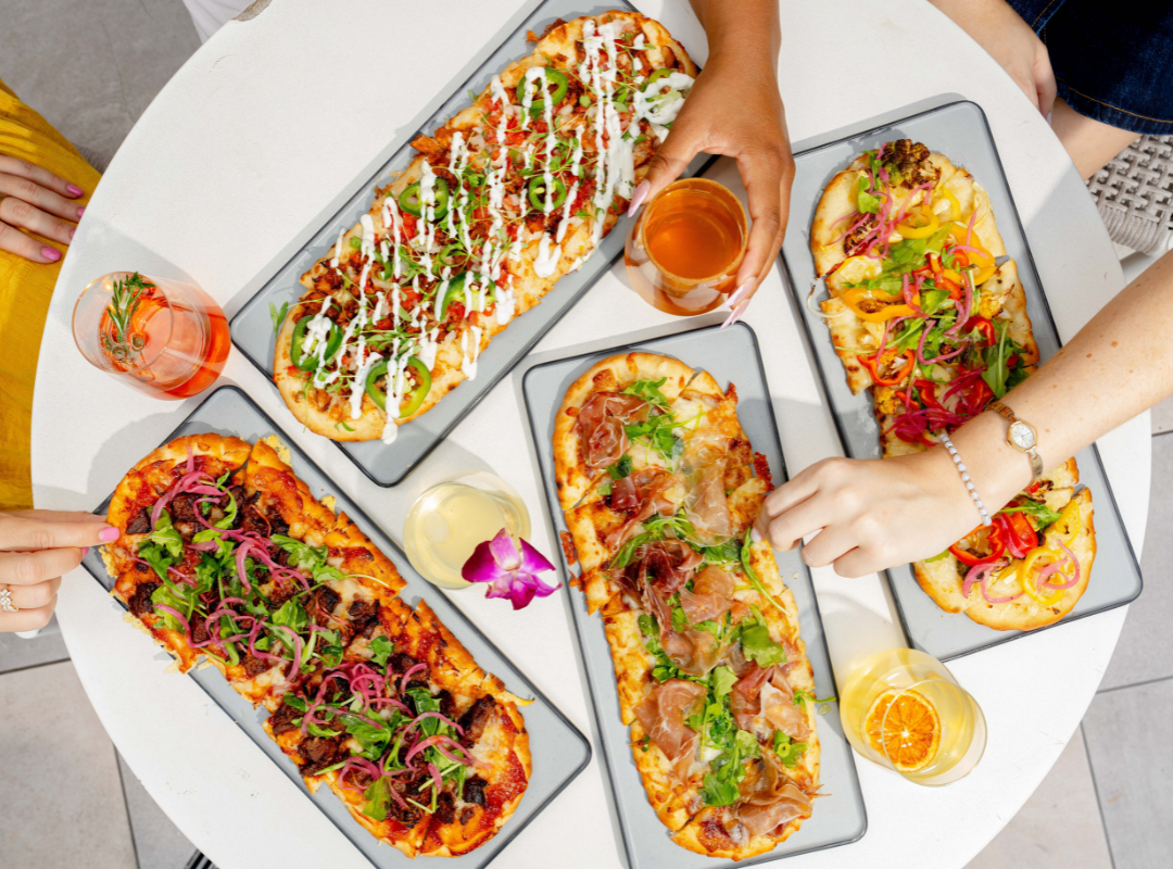 a group of rectangular pizzas with different toppings on them