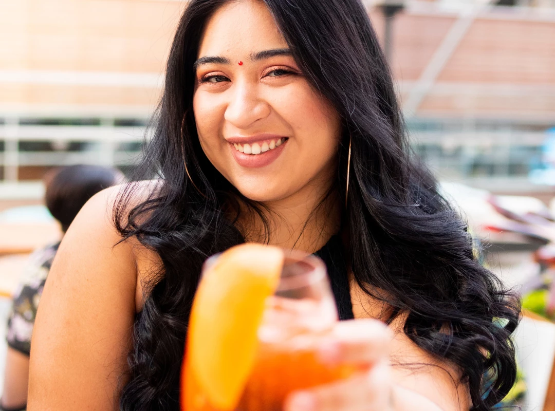 a woman holding a drink
