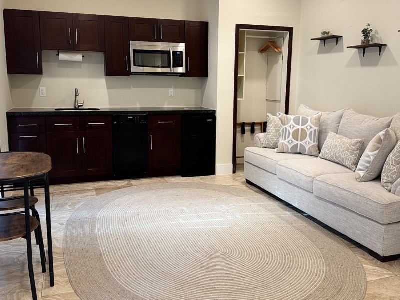 a living room with a couch and kitchen