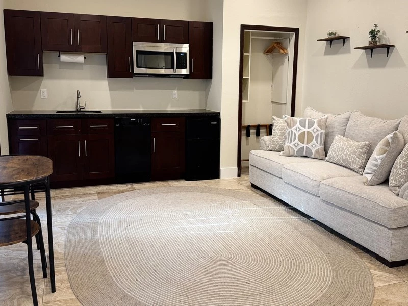 a living room with a couch and kitchen