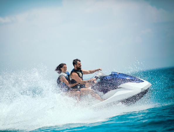 a man and woman on a jet ski