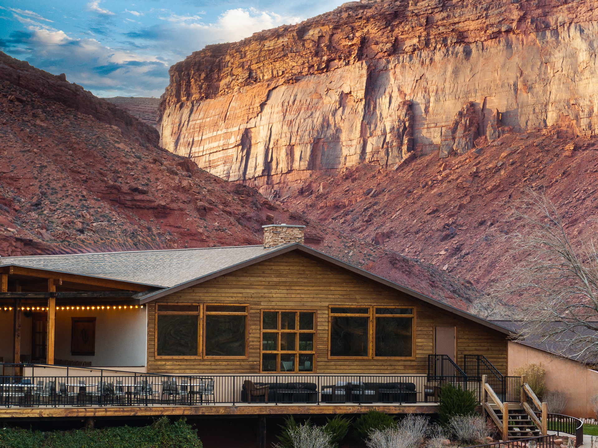 a house with a large rock formation in the background