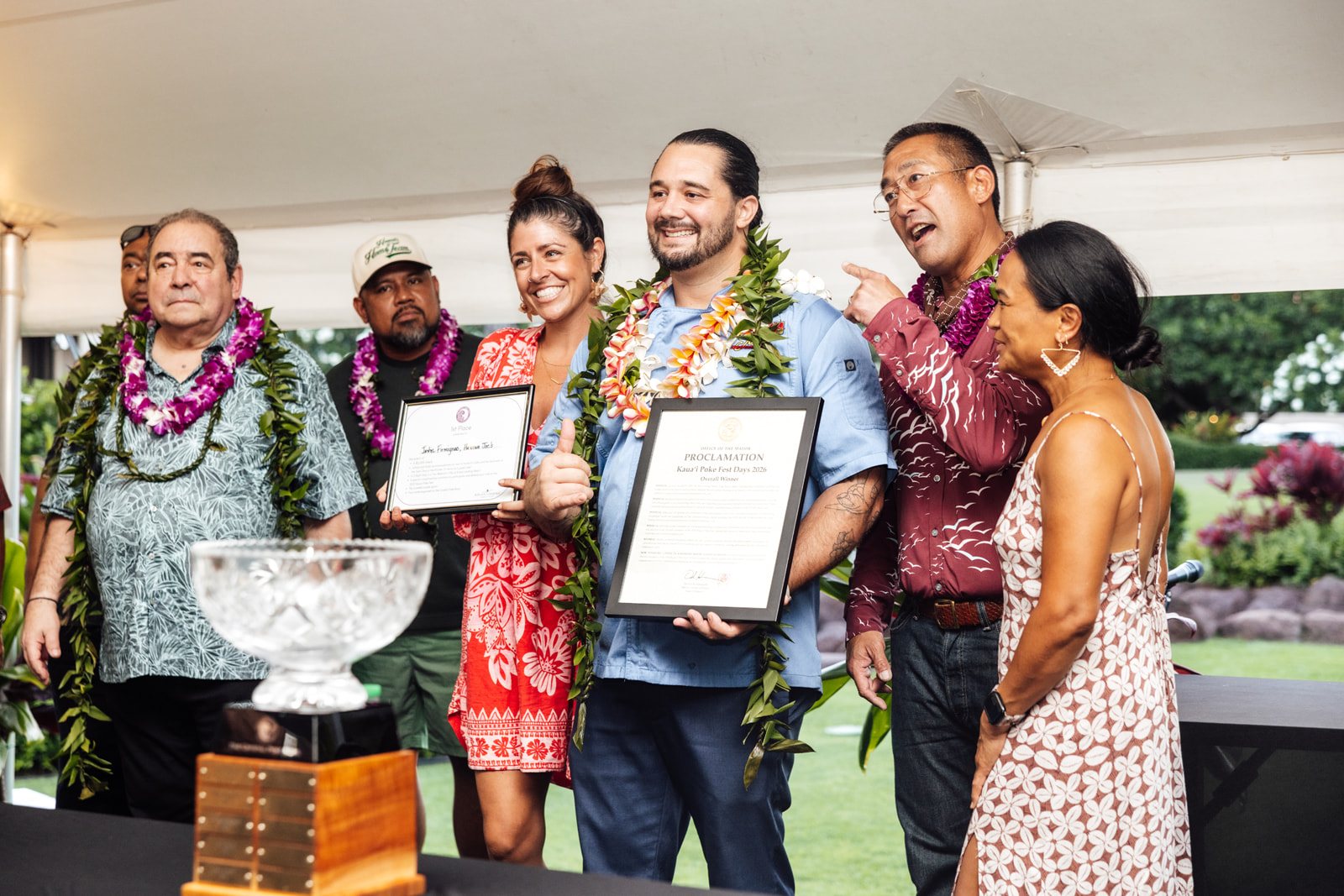 a group of people holding certificates