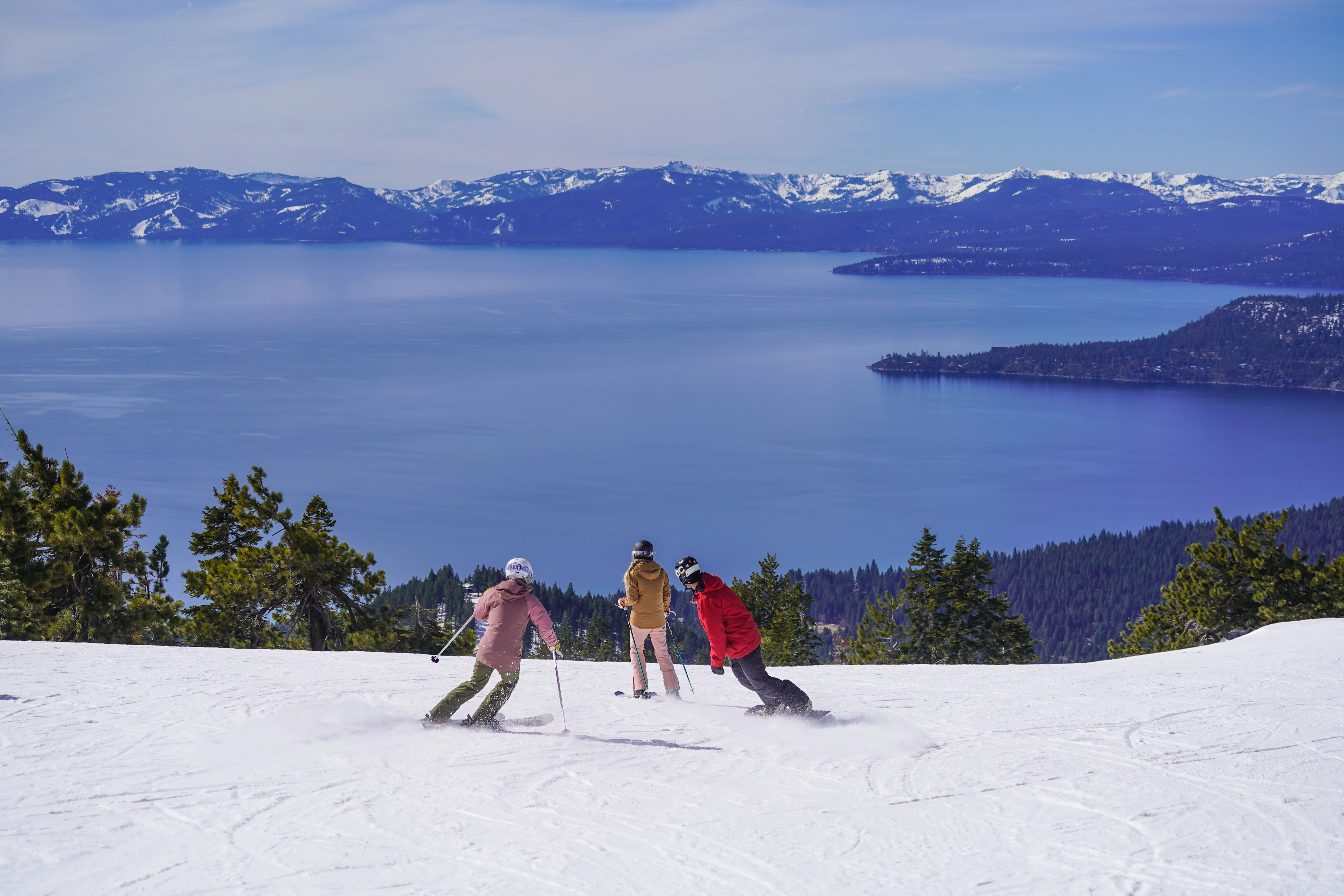 a group of people skiing on a snowy hill