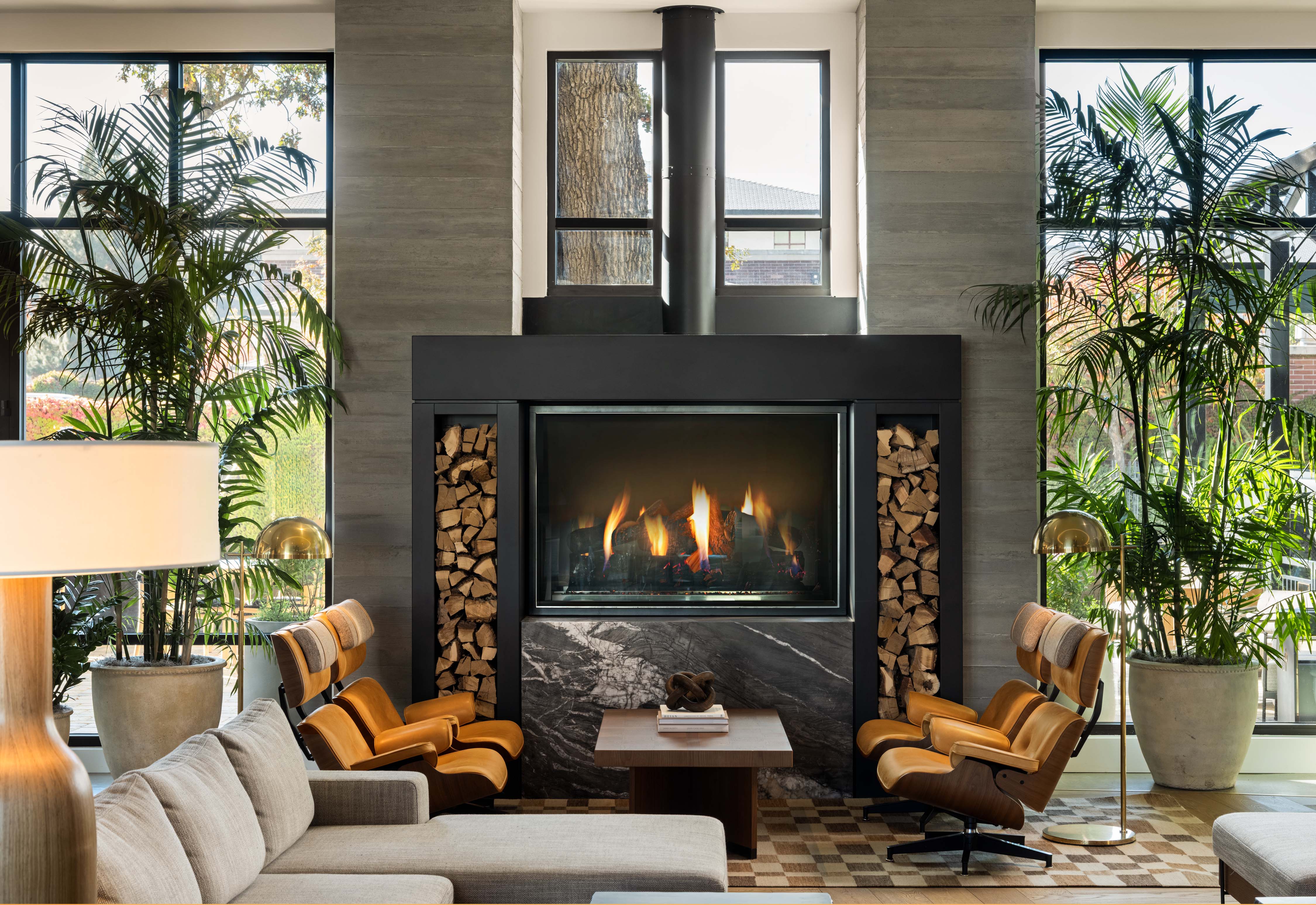 a room with a fireplace and chairs