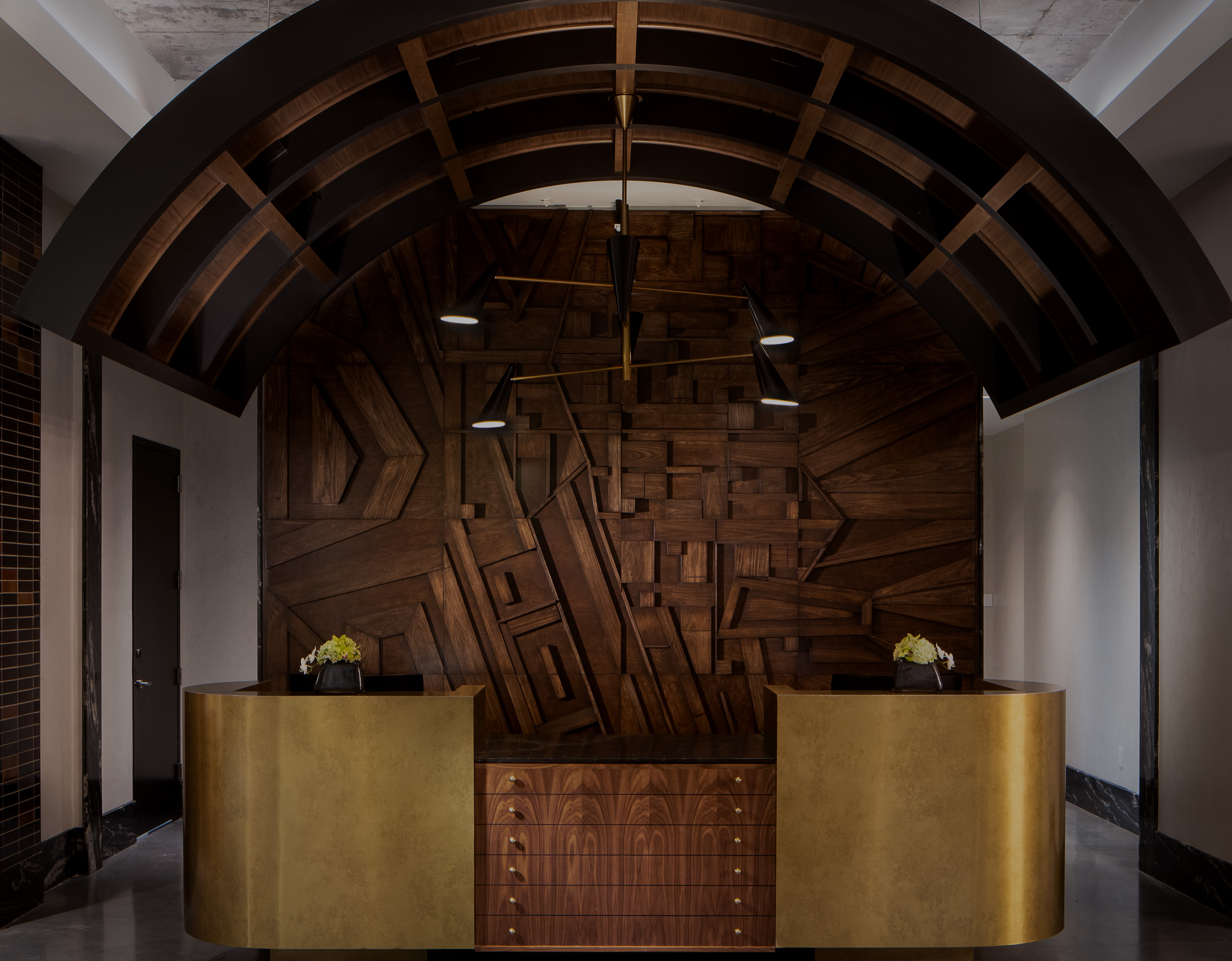 a wooden reception desk with a wood paneled wall
