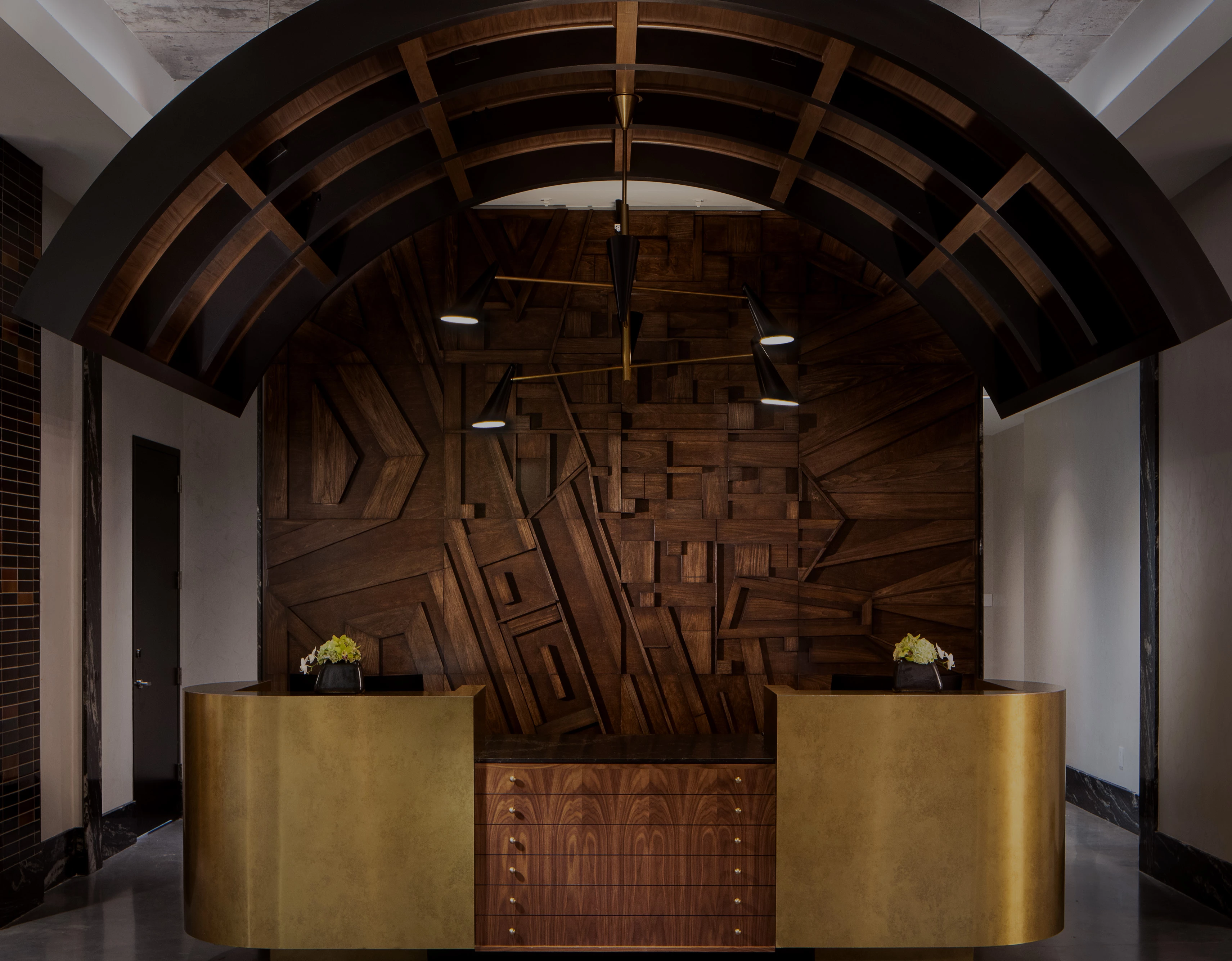 a wooden reception desk with a wood paneled wall