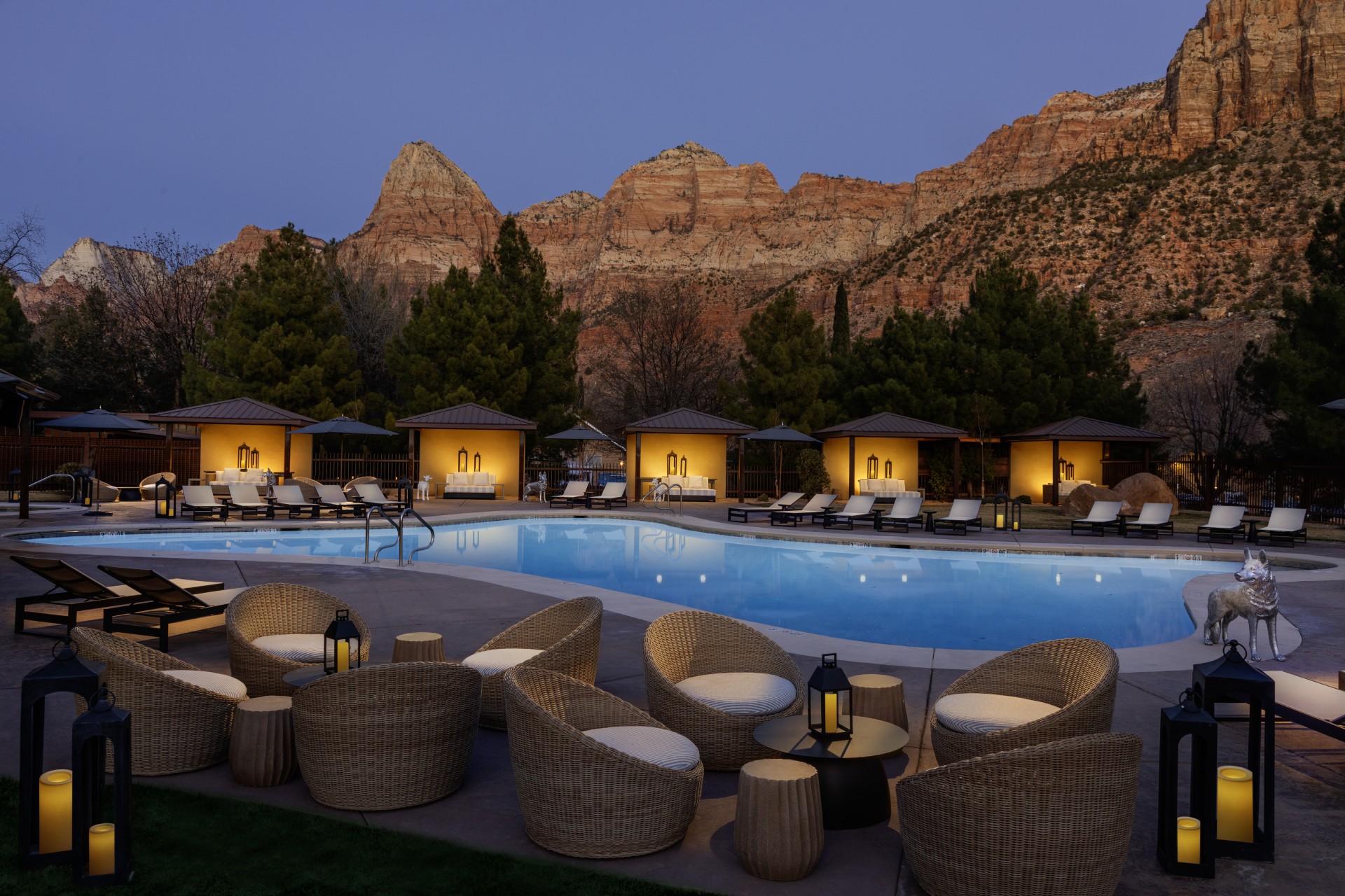 a pool with chairs and a mountain in the background
