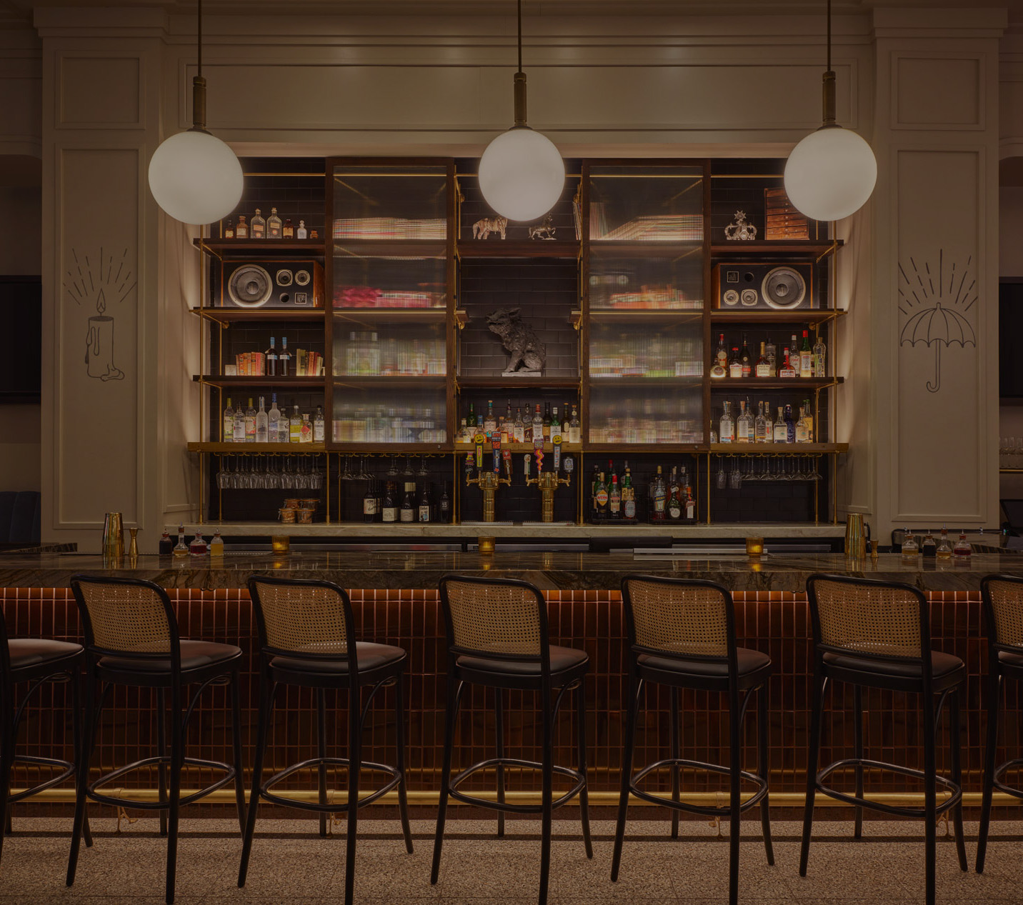 a bar with a row of chairs and a shelf with lights