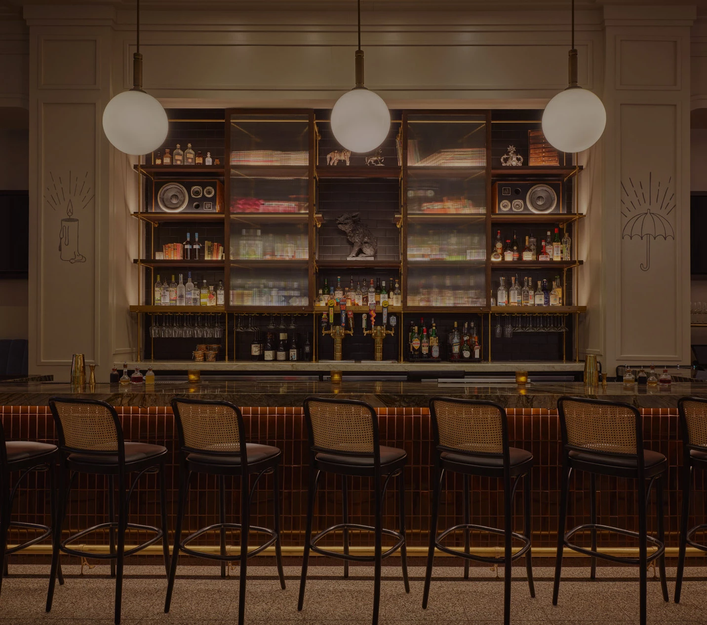a bar with a row of chairs and a shelf with lights