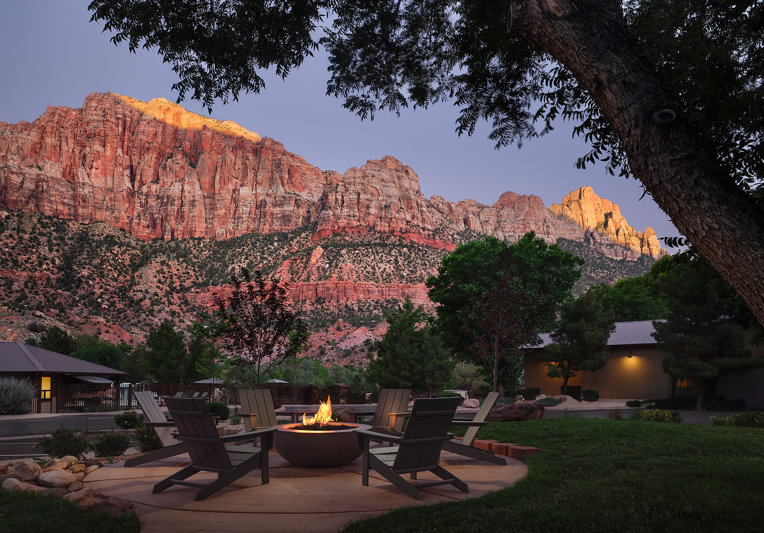 a fire pit in a backyard with a mountain in the background