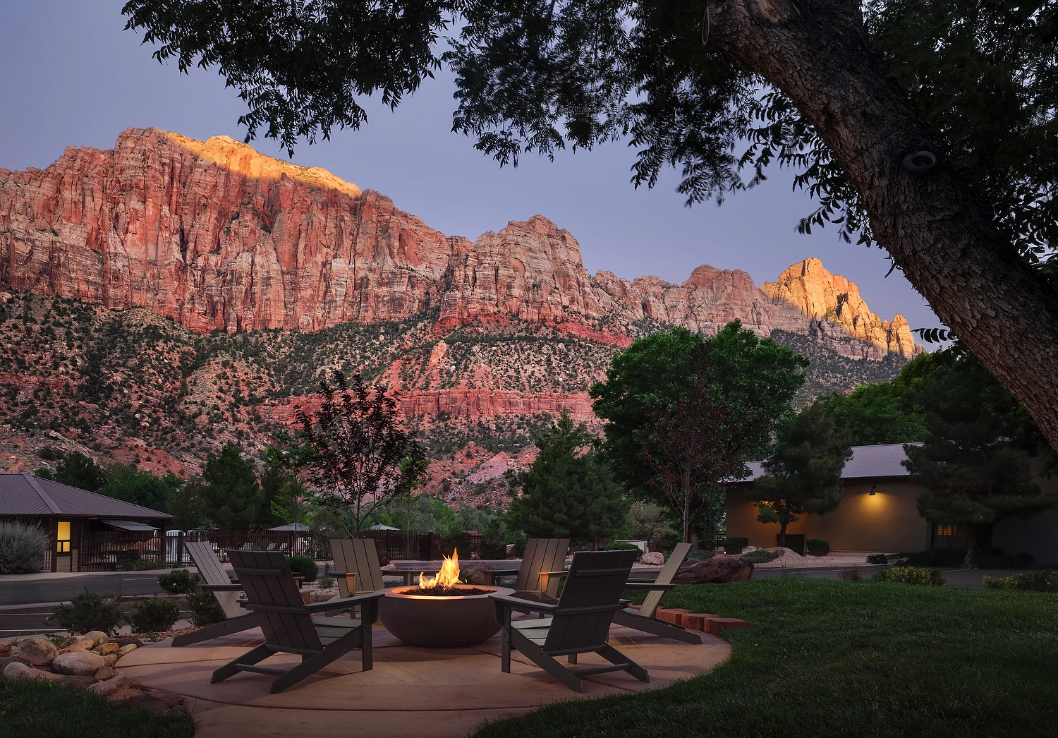 a fire pit in a backyard with a mountain in the background