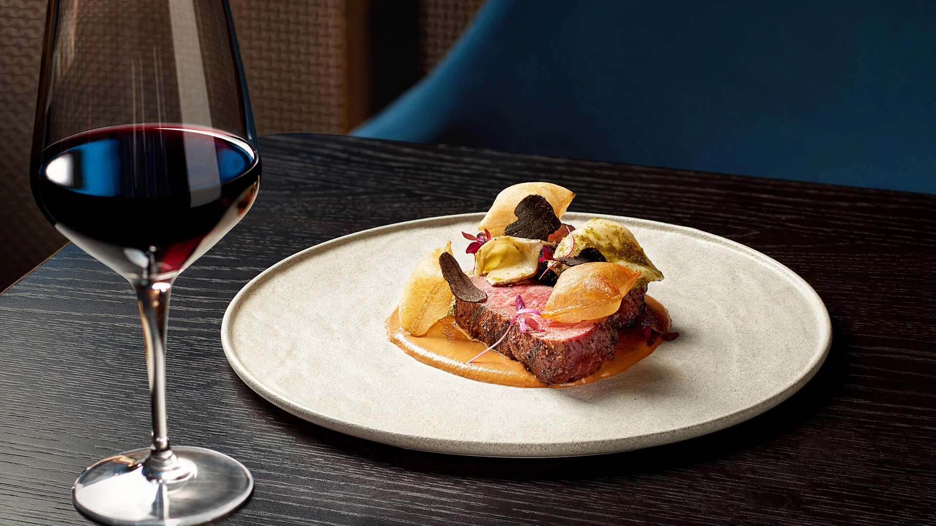a plate with a piece of steak on a table Next