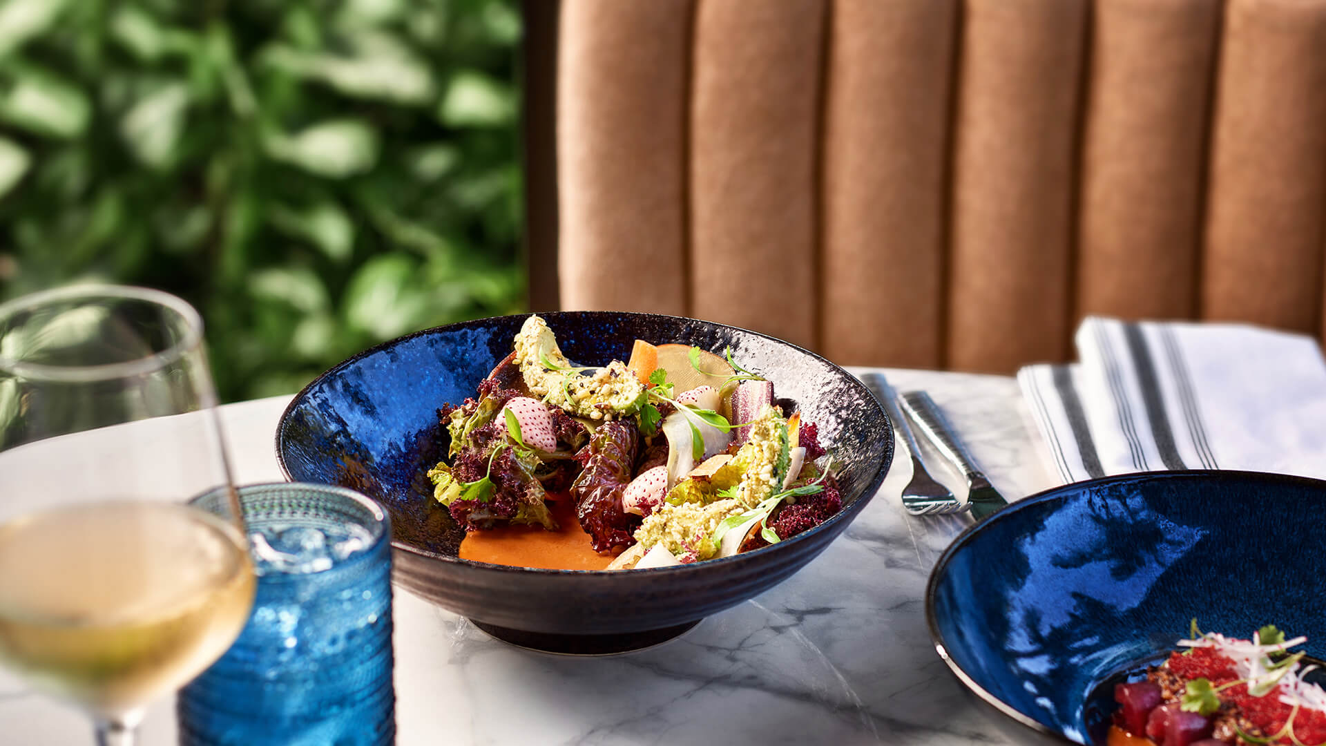 a bowl of salad on a table Preview