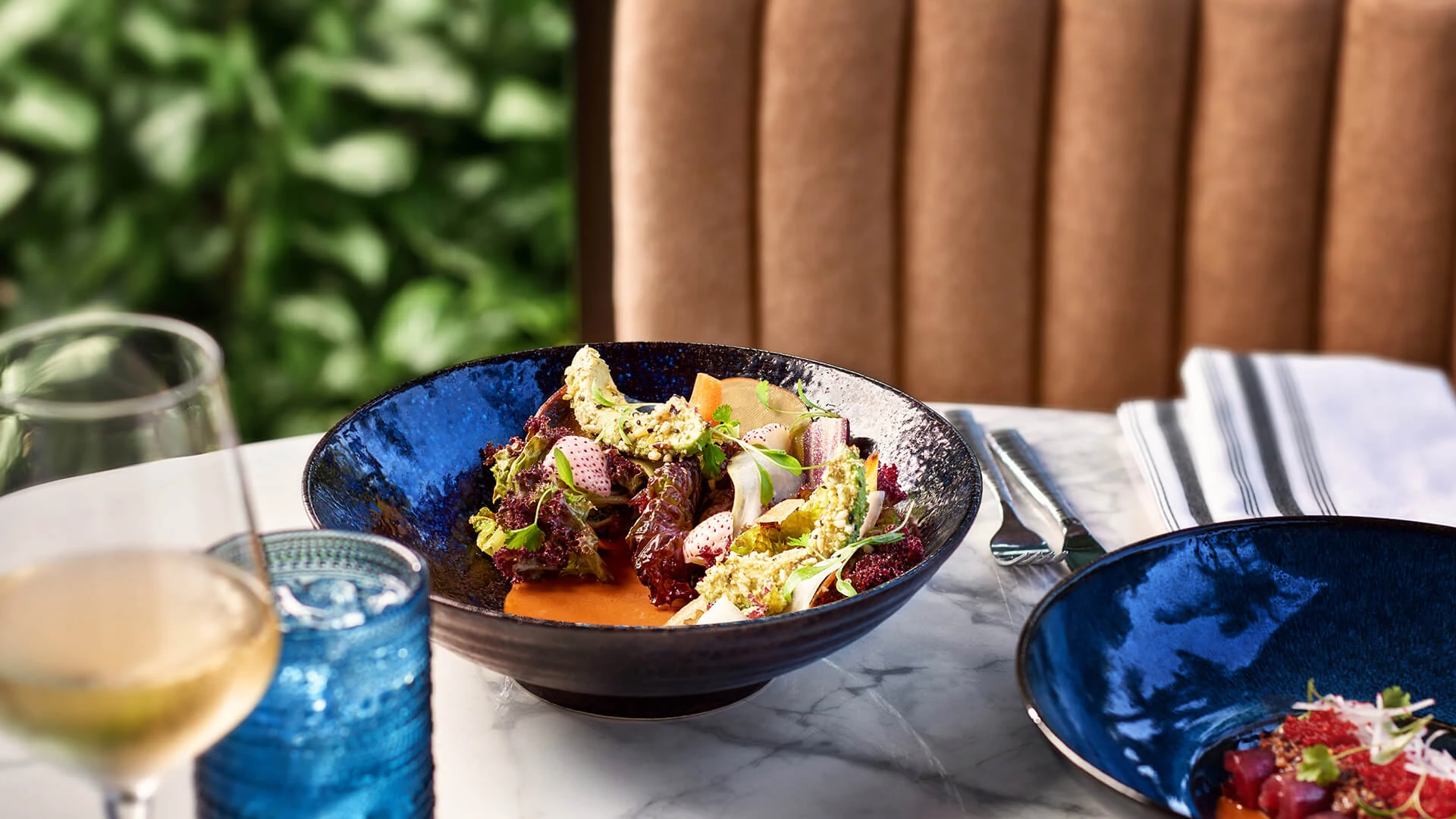 a bowl of salad on a table Preview