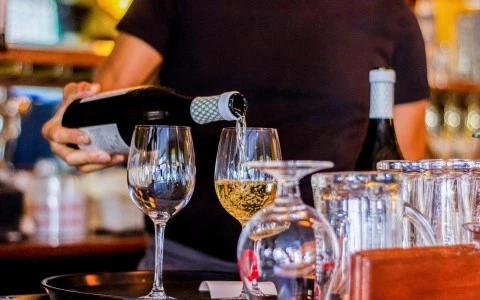 person pouring champagne in a glass 