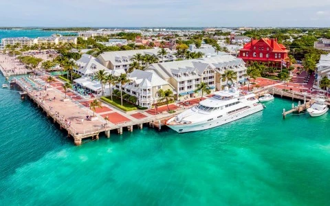 aerial image of a pier with a boat next to buildings