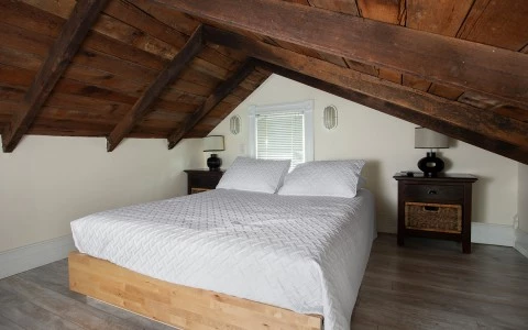 bedroom with a white bed and two side tables and lamps