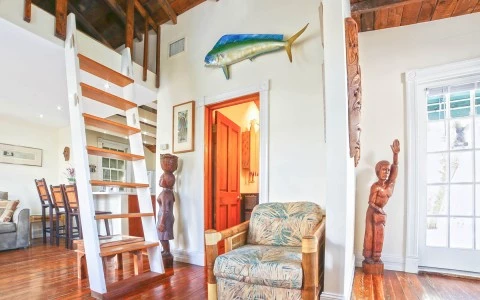 Cigar house interior with a fish on the wall wooden statues a chair and a ladder