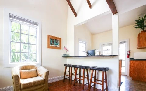 bar stool area in the conch house with a sitting chair under the window