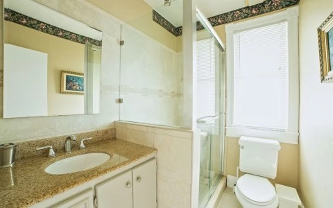 bathroom with a glass shower sink  and a toilet