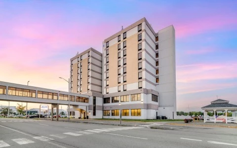 a large building with a walkway and a street