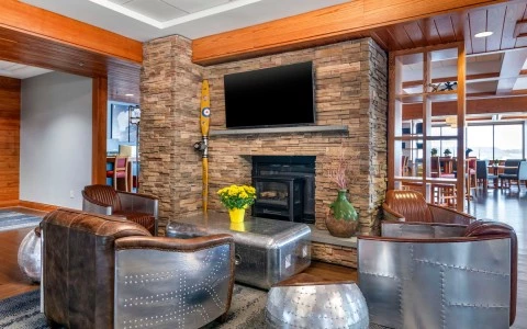 a room with a fireplace and chairs