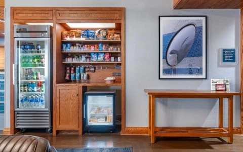a room with a refrigerator and a refrigerator and a shelf with snacks