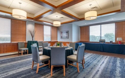 a room with a round table and chairs