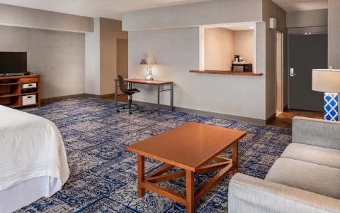 view of accommodation room with sitting area, desk, and kitchenette