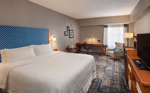 view of King bed accommodations with sitting area and desk