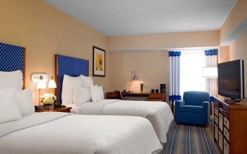 view of 2 double bed accommodations with sitting area and desk