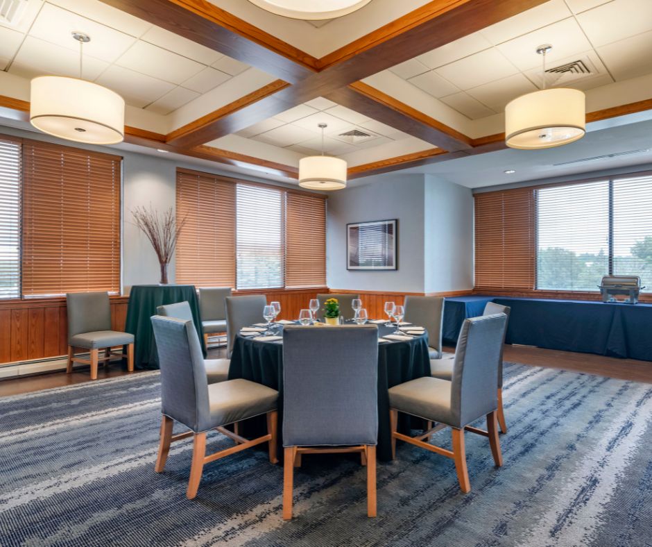 a room with a round table and chairs
