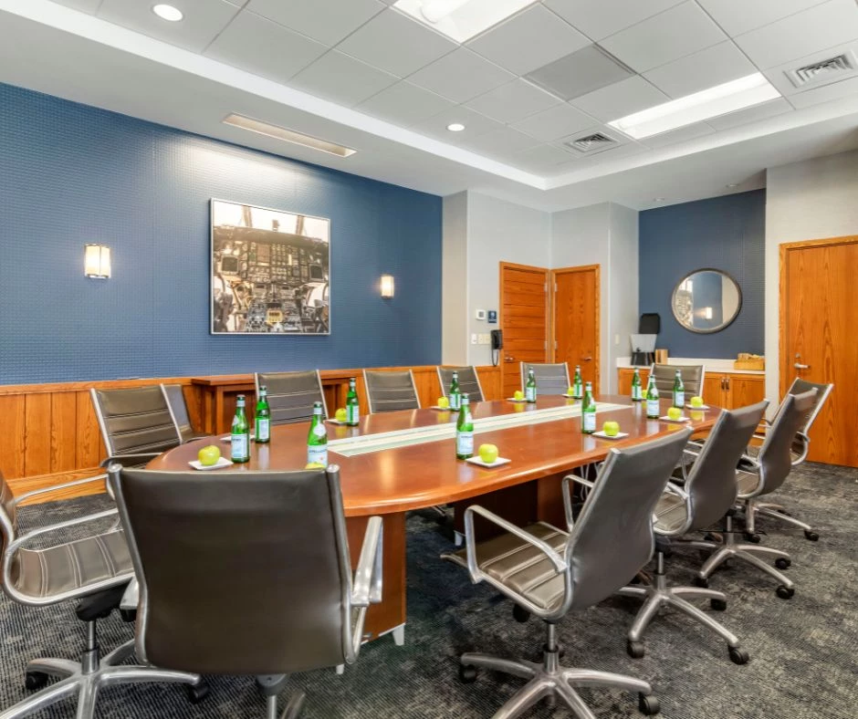 a conference room with a table and chairs