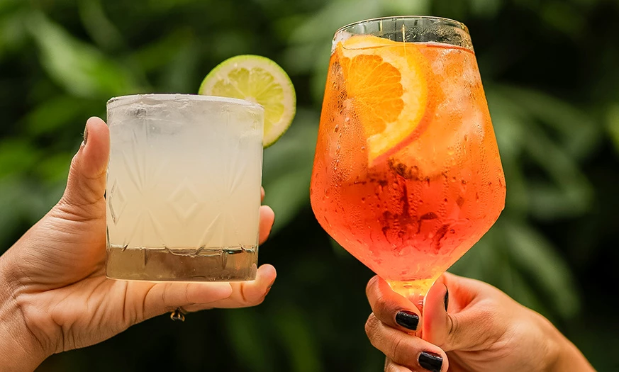 a pair of hands holding drinks