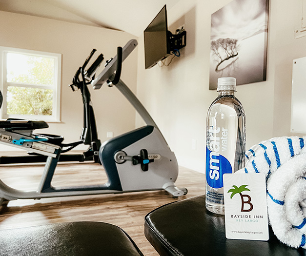 a bottle of water and a ball on a bench in a gym
