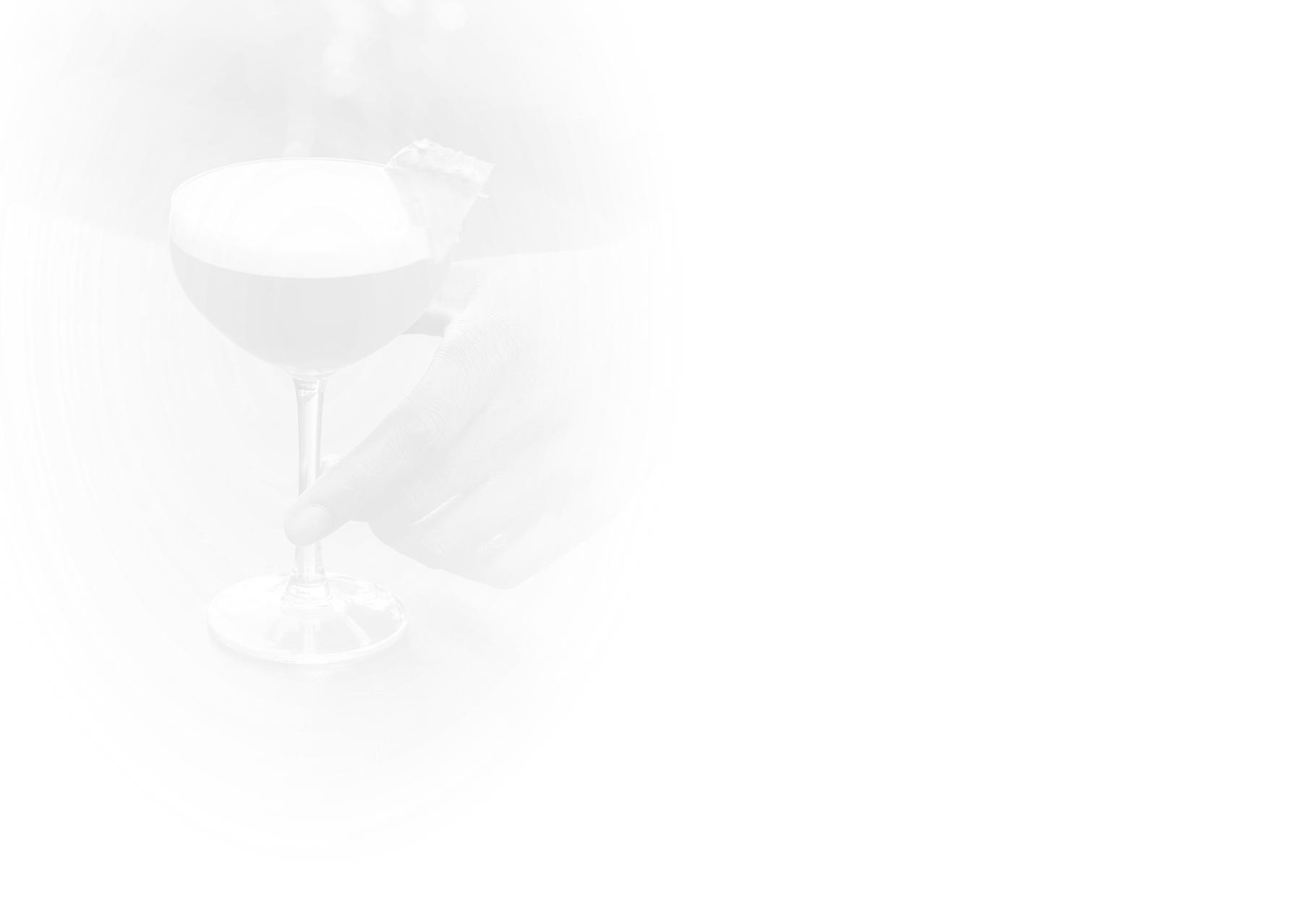 a hand holding a glass of liquid