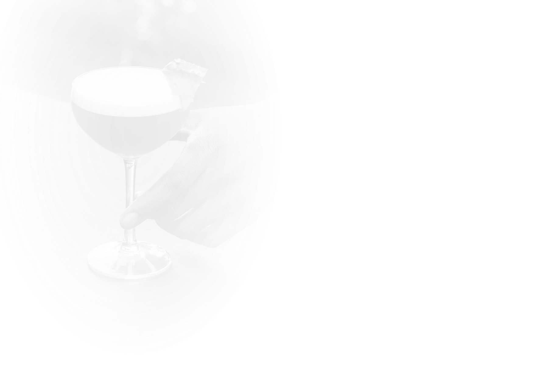 a hand holding a glass of liquid