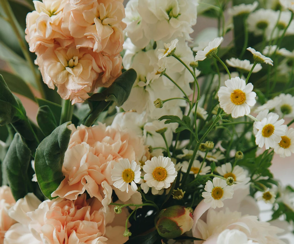 a bouquet of flowers with green leaves