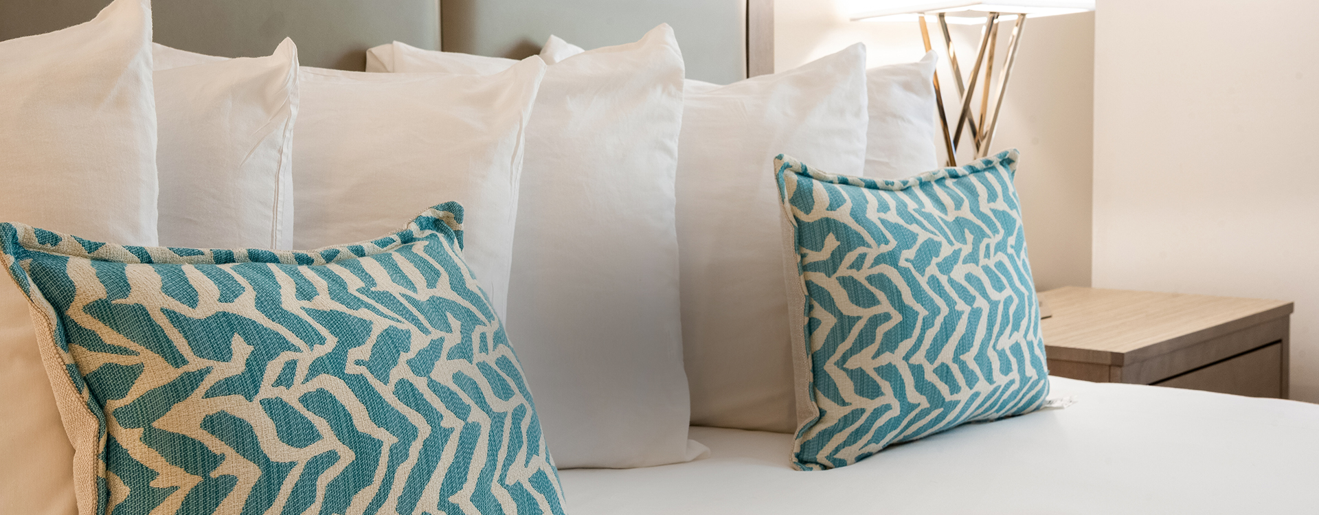a group of pillows on a bed