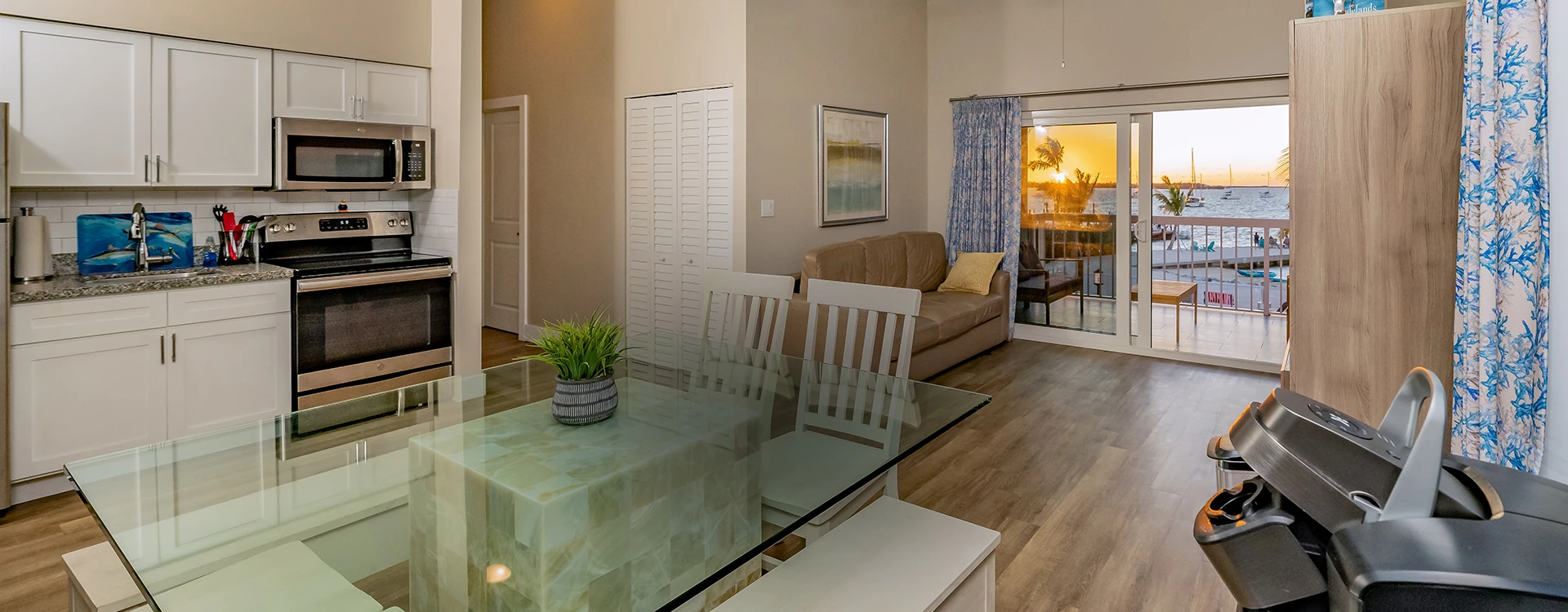 a living room with a glass table and a couch