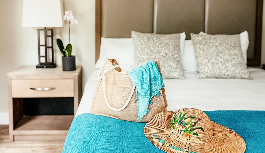 a hat and bag on a bed