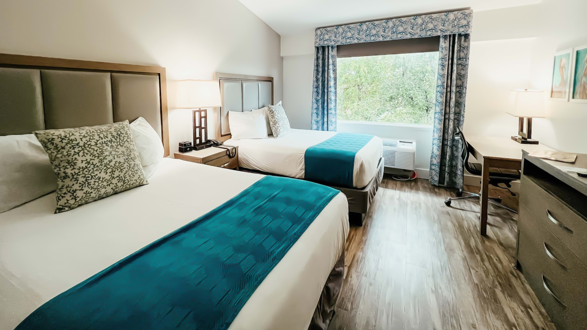 a room with two beds and a window