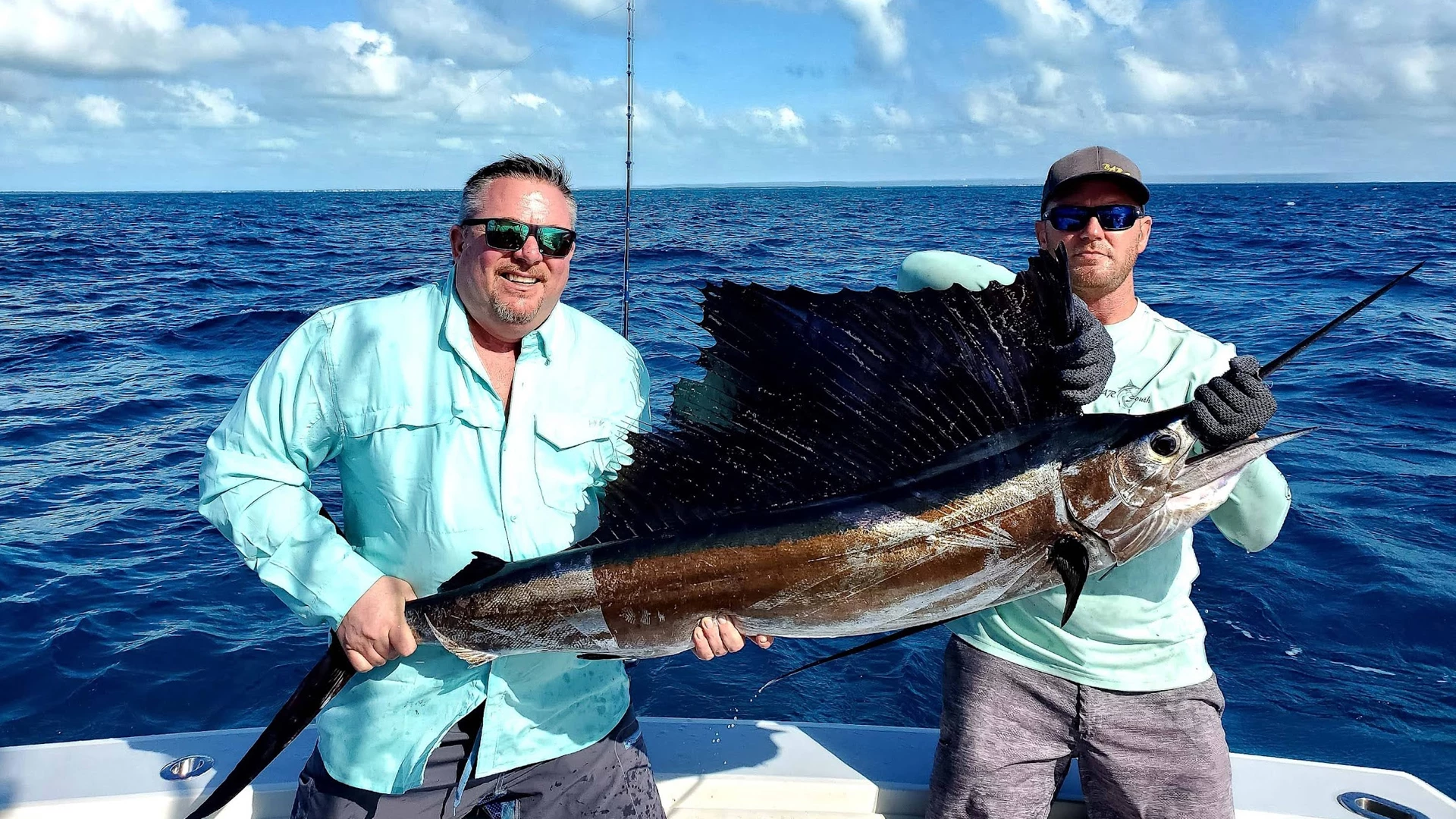 two men holding a large fish