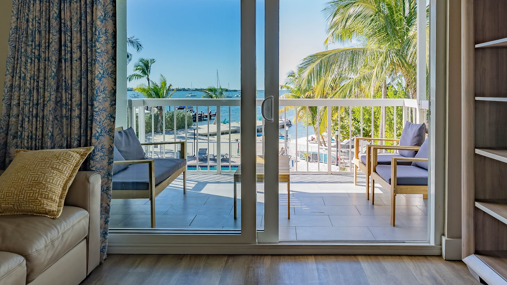 a patio with a view of the water and a boat