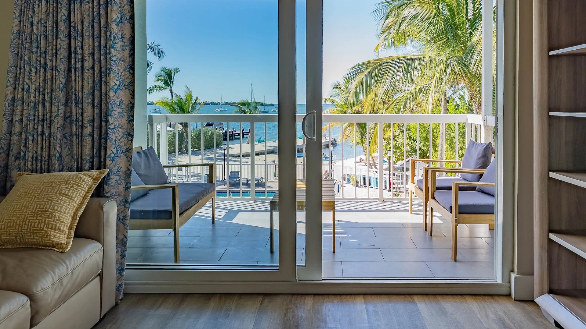 a patio with a view of the water and a boat