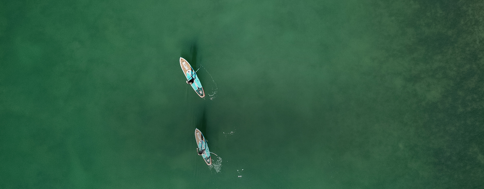 a couple of people paddling kayaks in the water