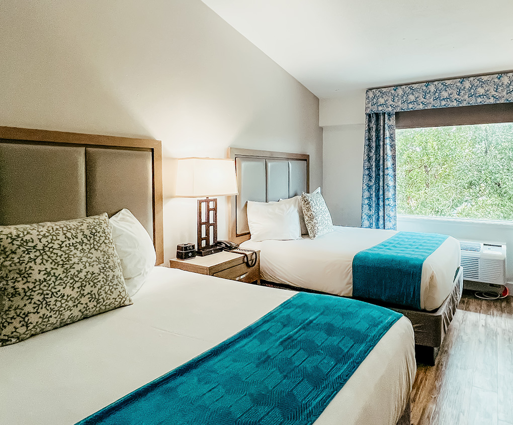 a room with two beds and a window